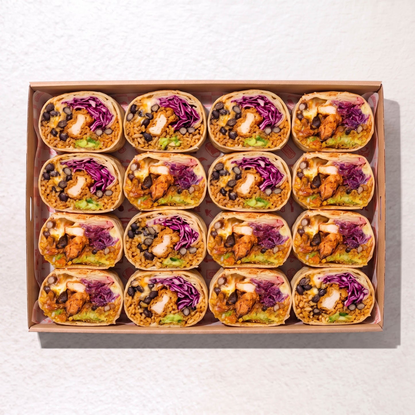 Muy Muy burrito box from Double Dribble Catering Christchurch — soft flour-wrapped burritos with guacamole, black beans, fresh salad and chicken, boxed for sharing.
