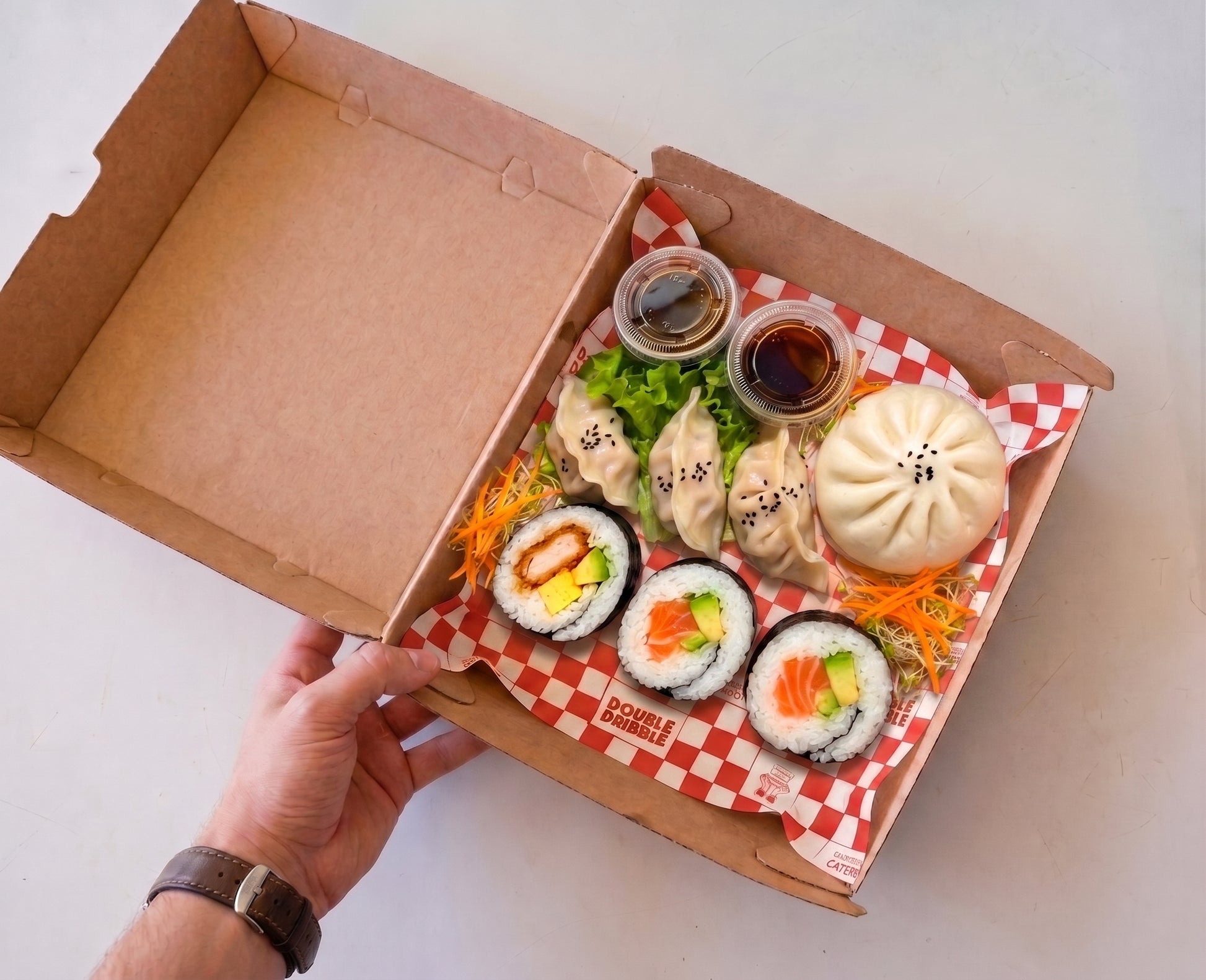 $26pp I Feel Good box from Double Dribble — dumplings, honey BBQ pork bun and Eightgrains sushi — office team lunch catering in Christchurch
