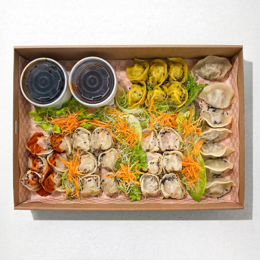 Mixed Dumpling Platter (33pc) from Double Dribble — pork, prawn, chicken and vegan dumplings, shumai and wontons with dipping sauces in a kraft catering box