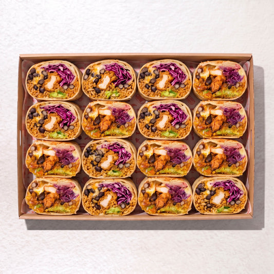 A top-down view of a brown cardboard tray holding 12 burritos arranged in a grid. Each burrito is filled with rice, black beans, avocado, shredded purple cabbage, and chicken. by Muy Muy Christchurch