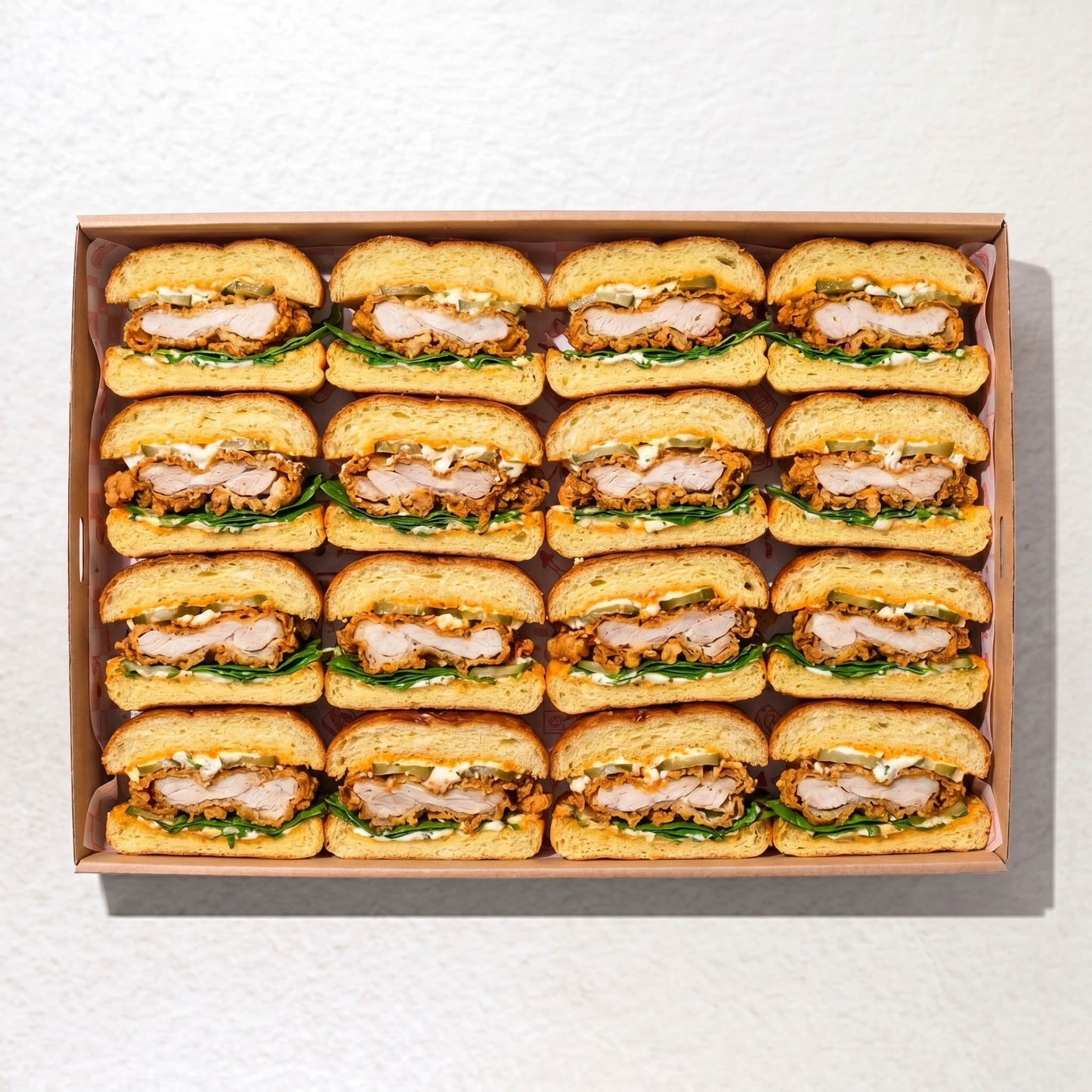 Soft Milk Bun Sandwich box from Double Dribble — pillowy milk buns filled with crispy fried chicken, house sauces, gherkins and lettuce, halved for sharing