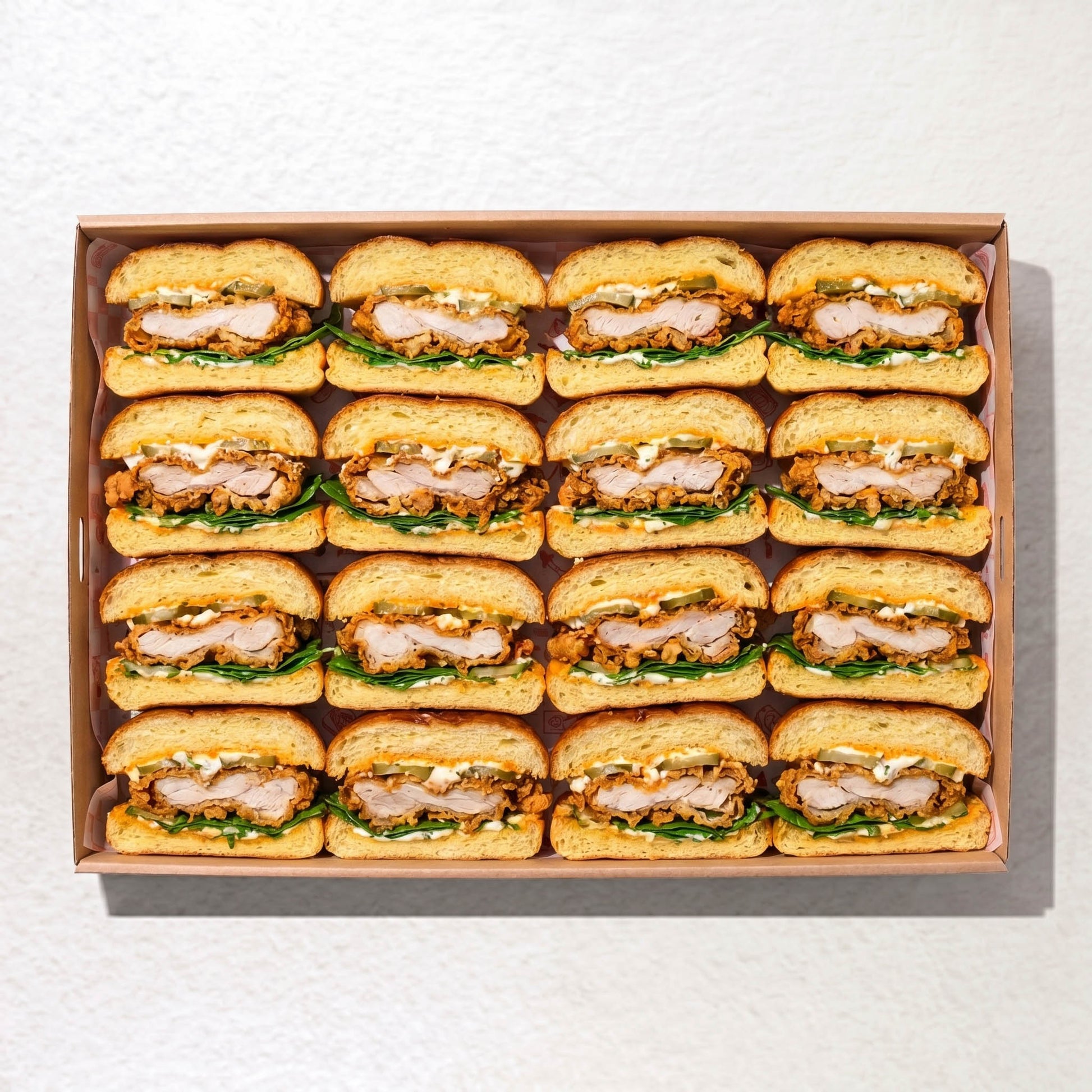 Soft Milk Bun Sandwich box from Double Dribble — pillowy milk buns filled with crispy fried chicken, house sauces, gherkins and lettuce, halved for sharing